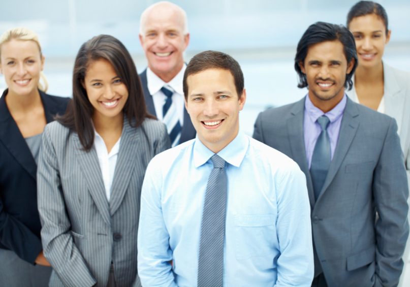 A group of successful and satisfied businesspeople looking upwards smiling